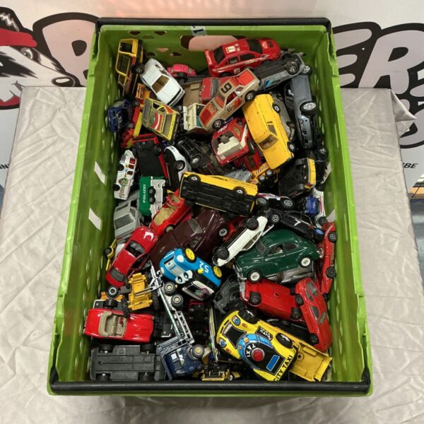 Green crate filled with assorted diecast model cars and taxis
