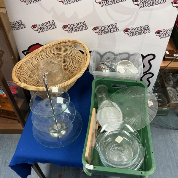 Assorted glassware lot with glass cake stand, dishes and vases on table