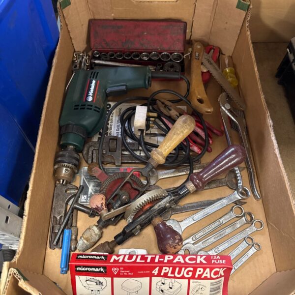 Assorted hand tools in a tray, including wrenches and pliers.