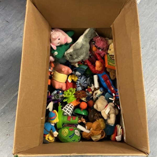 Overview of assorted toy lot with action figures and plush toys.