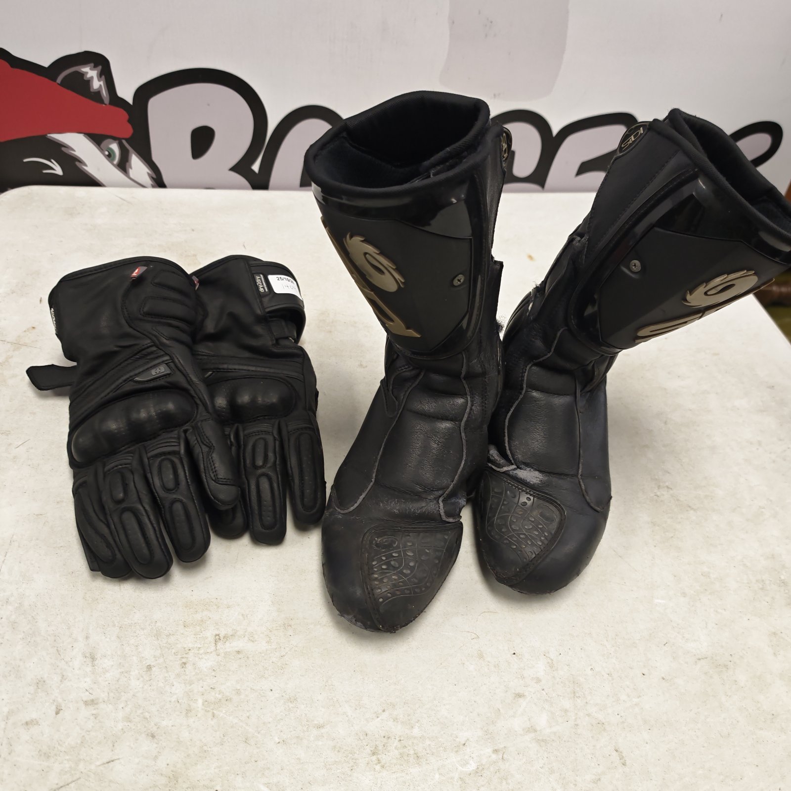 Pair of black leather Audi motorcycle boots beside dry2dry motorcycle gloves