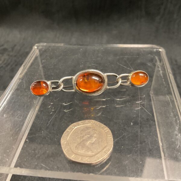 Vintage silver brooch with three Baltic amber cabochons.