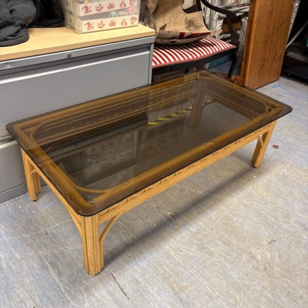 Vintage bamboo coffee table with smoked glass top and rattan details.