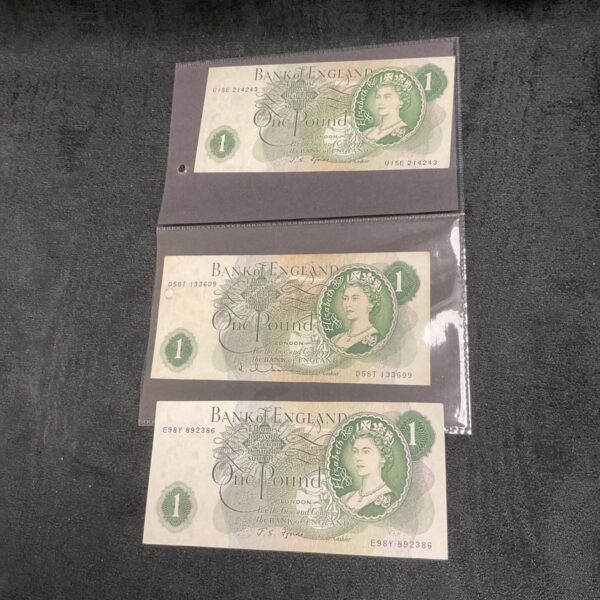 Three Bank of England One Pound notes, vintage British currency.