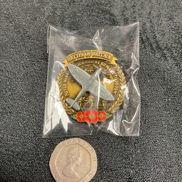 Battle of Britain poppy pin badge with rotating Spitfire aircraft.