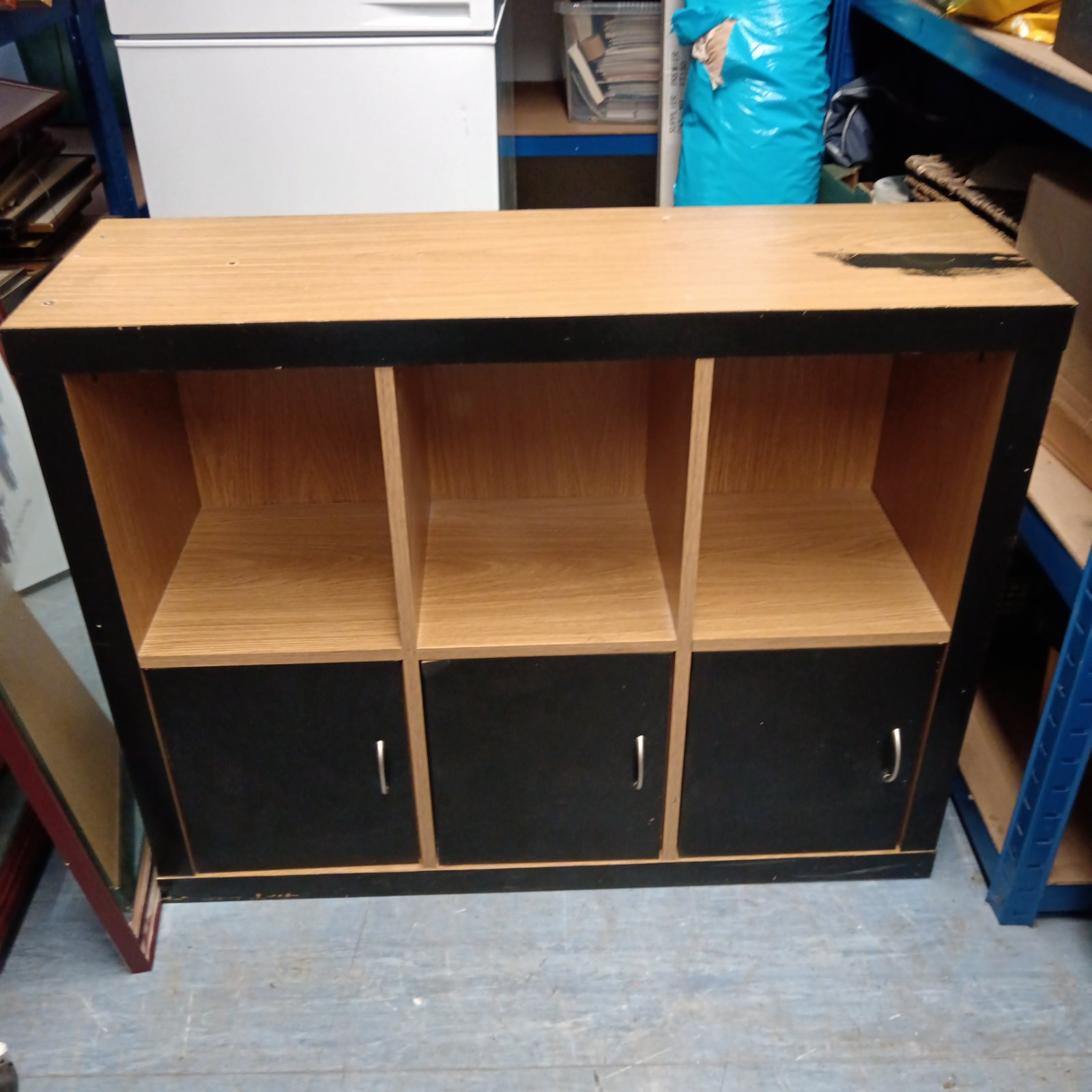 Beech effect hall cabinet with three doors for storage.