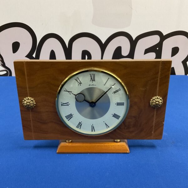 Front view of mid century Bentima mantle clock with walnut-effect case