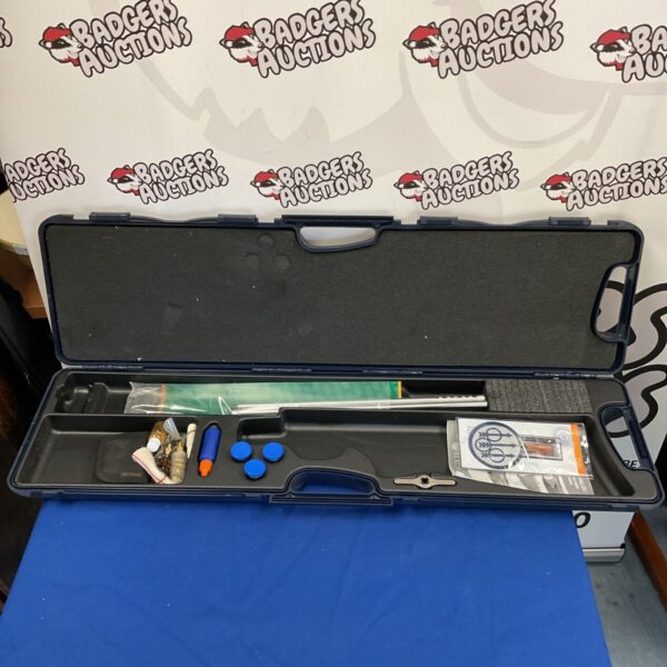 Open Beretta shotgun case displaying interior and cleaning kit.