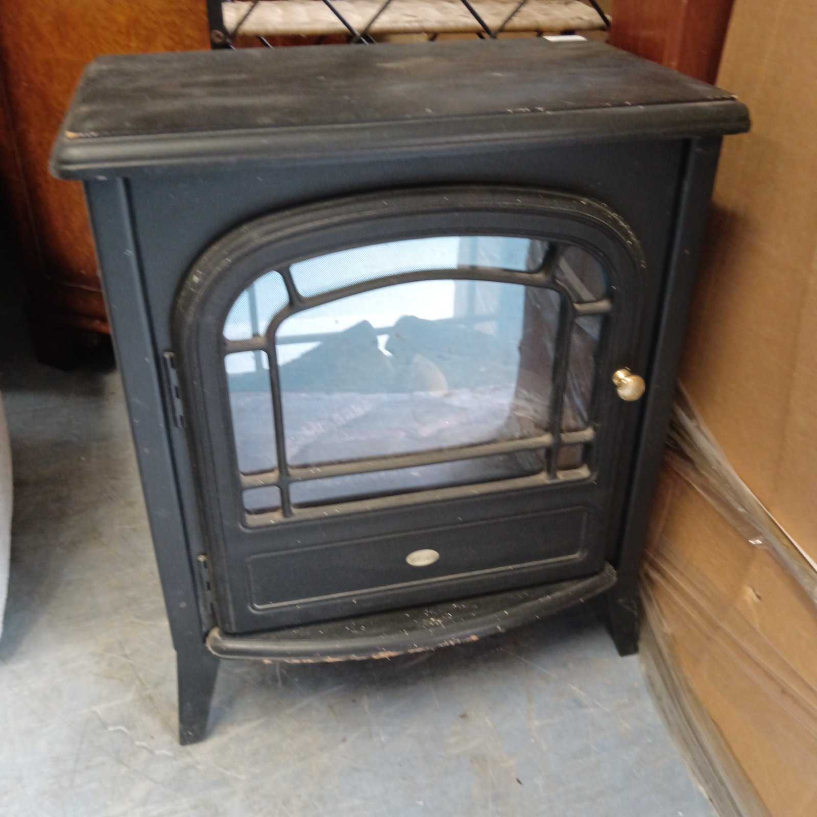 Black club electric fireplace with a curved front and faux hearth.