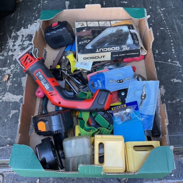 Black & Decker handy saw in a tray of tools and hardware.