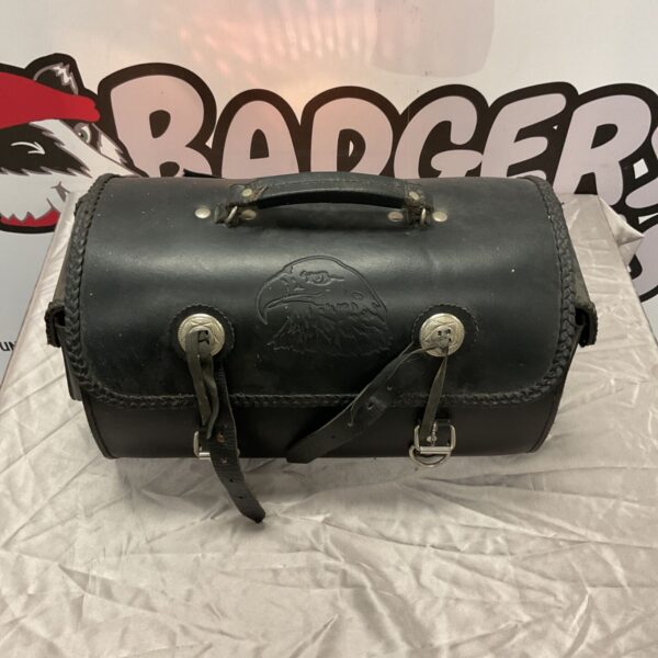 Black leather motorcycle top roll bag with embossed eagle head and braided trim