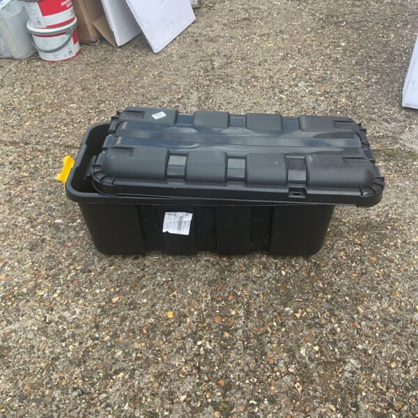 Black plastic storage box with a lid, showing signs of use.