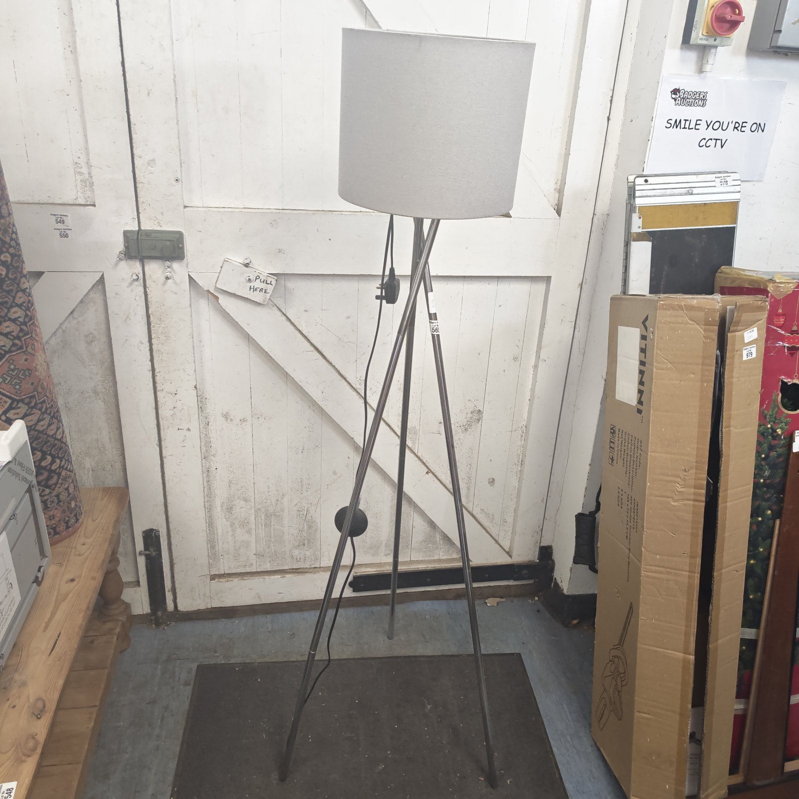 Black tripod standard lamp with adjustable head, vintage lighting.