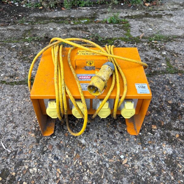 Yellow Blakley Electrics 110V site power distribution box with carry handle.