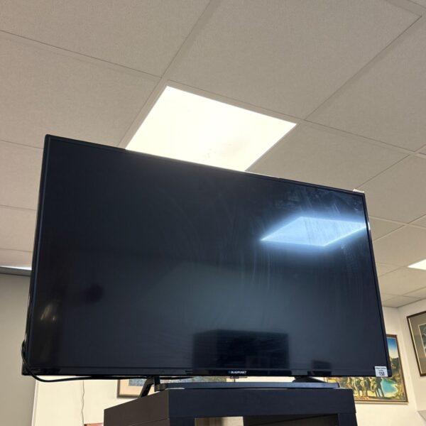 Black Blaupunkt 40 inch LED television on a stand, front view