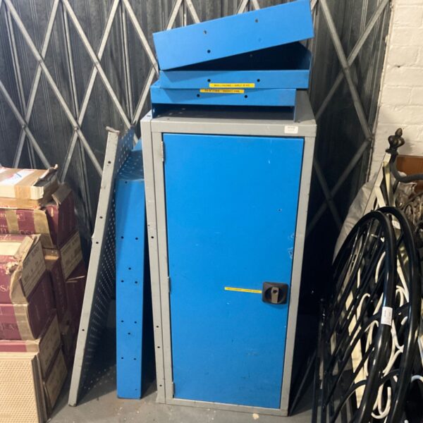 Blue and grey metal storage locker with stacked shelf trays on top
