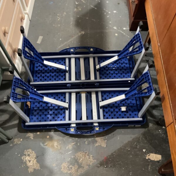 Blue plastic folding table with silver metal frame and folding legs