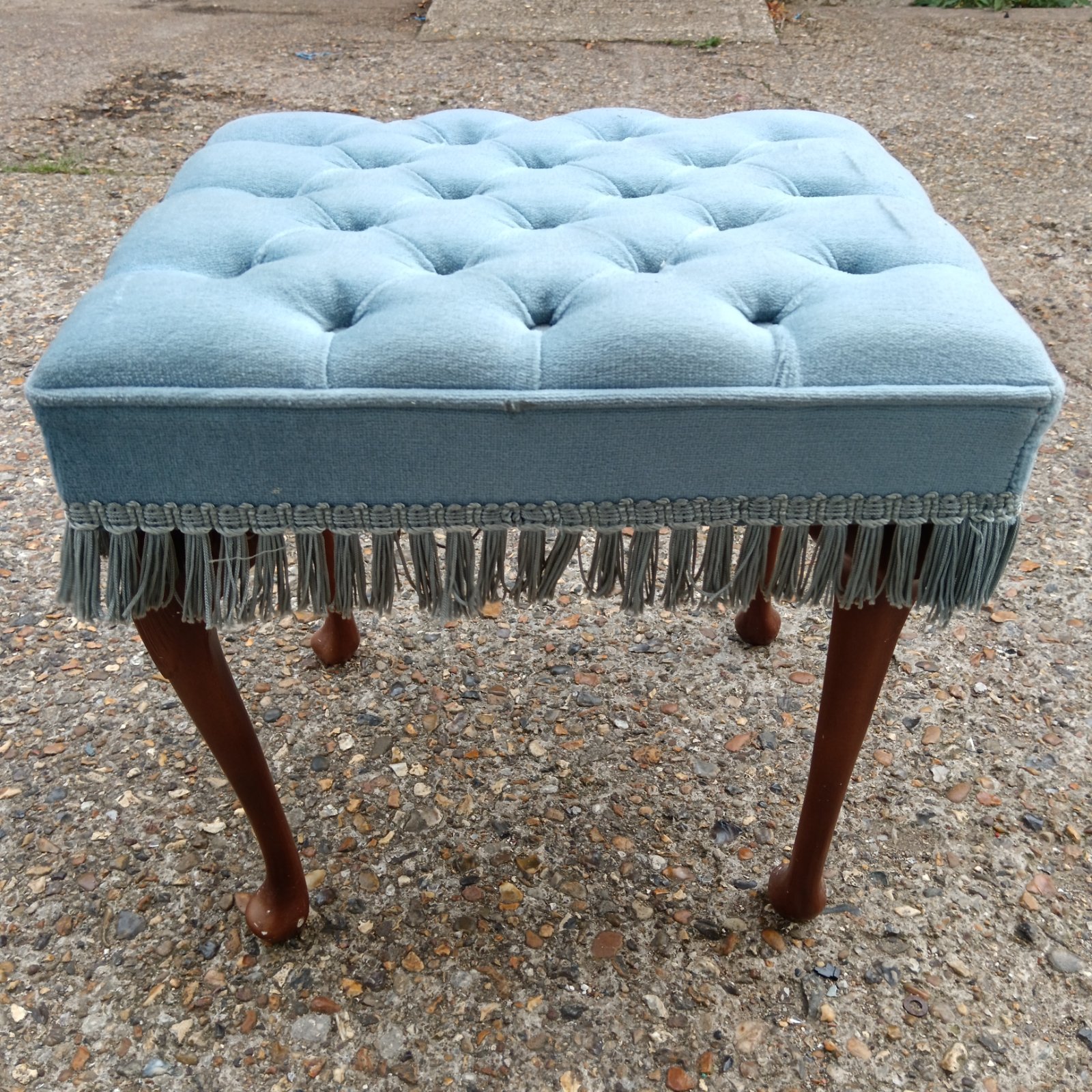 Vintage blue tasseled dressing table stool with wooden legs.