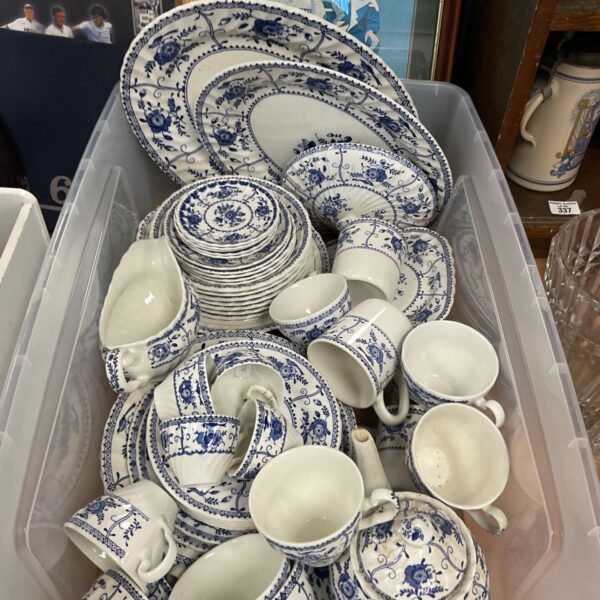 Blue and white porcelain dinner service with floral patterns.