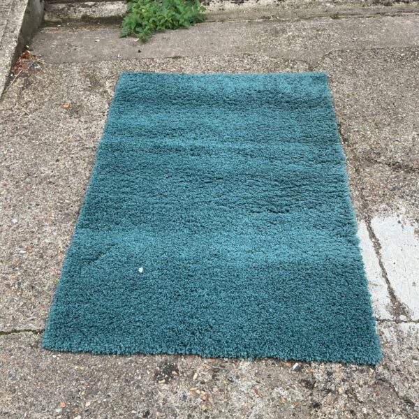 Vibrant blue wool rug measuring 73x54 inches.