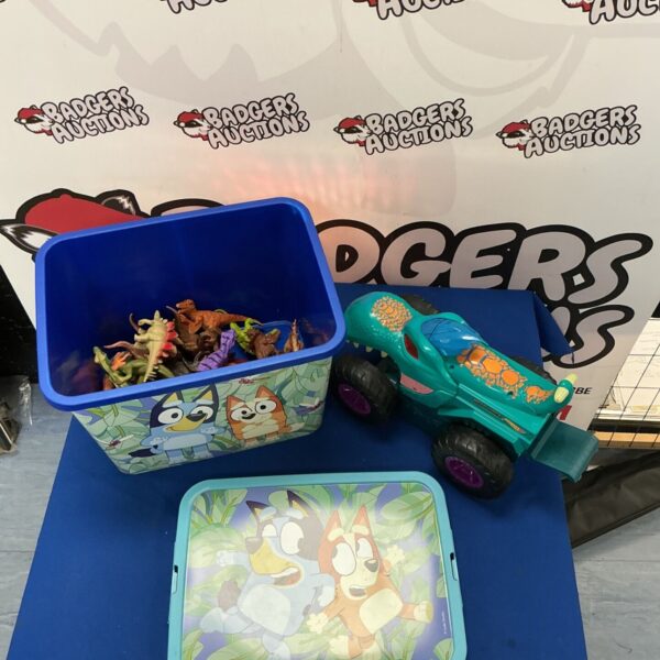 Bluey toy box filled with Hot Wheels and dinosaur figures.