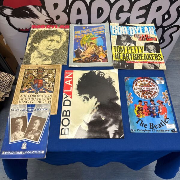 Mixed lot of Bob Dylan concert programmes and commemorative souvenir programmes on blue cloth
