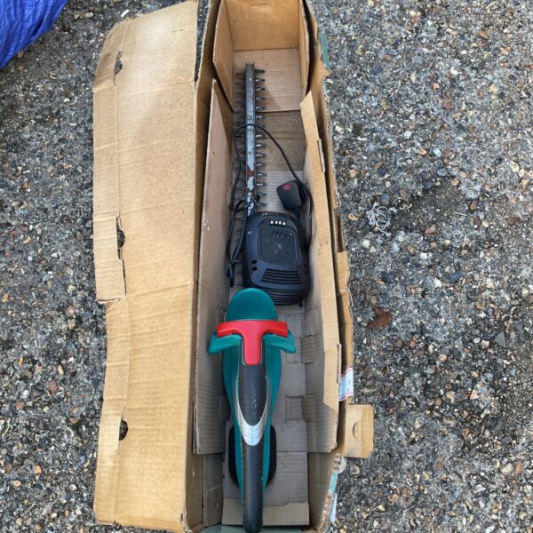 Bosch electric hedge trimmer displayed inside a cardboard box.
