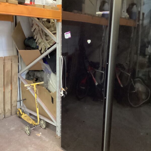 Tall black Bosch full length fridge with stainless steel-effect side trim