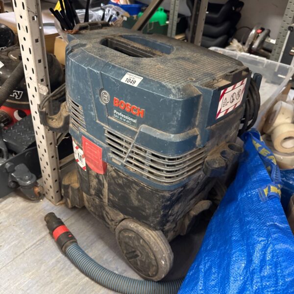 Bosch Professional GAS 35 M AFC dust extractor in a workshop setting.
