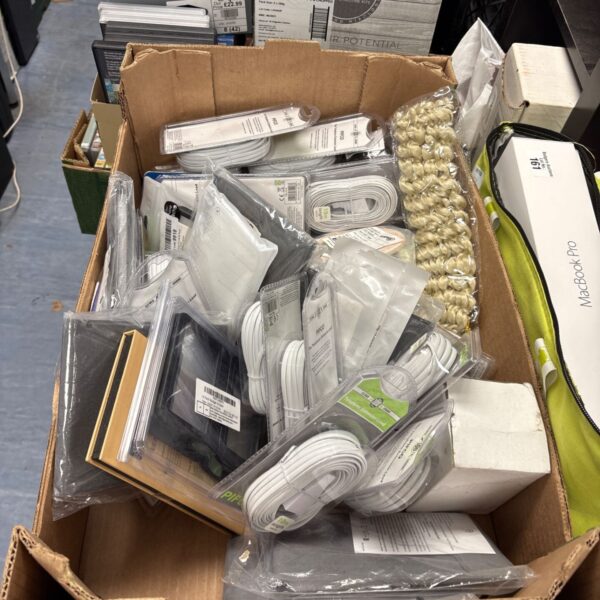Cardboard box of new white telephone cables and electrical accessories in packaging