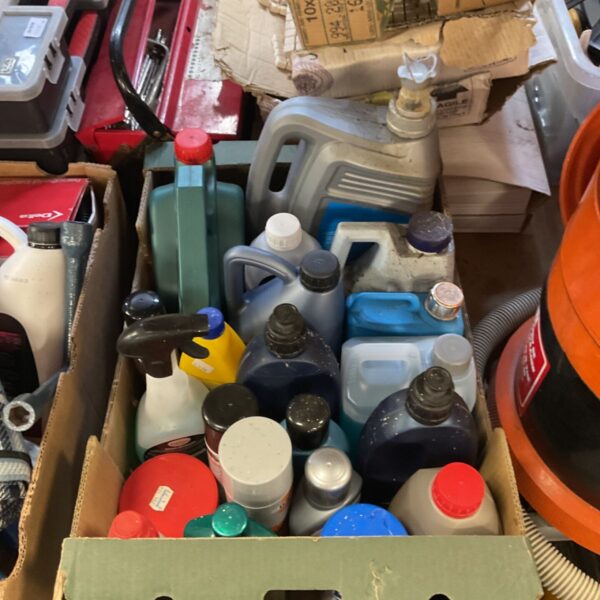 Cardboard box of assorted car cleaning containers and spray bottles in mixed colours