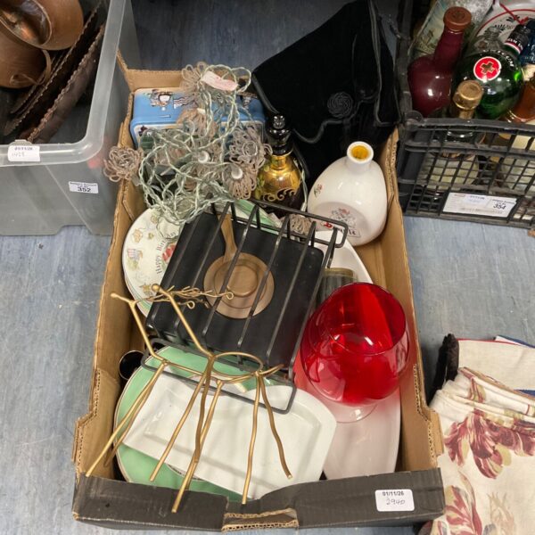 Box of mixed items including a large red glass goblet and wire plate stands