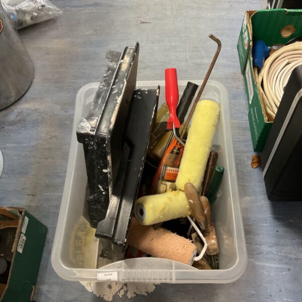 Box of painting equipment with paint rollers, a paint tray and hand tools