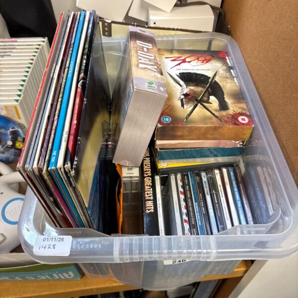 Clear plastic box containing vinyl records, DVDs and CDs including 300 box set