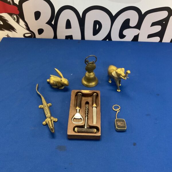 Vintage brass ornaments and bottle opener set with bone handles.