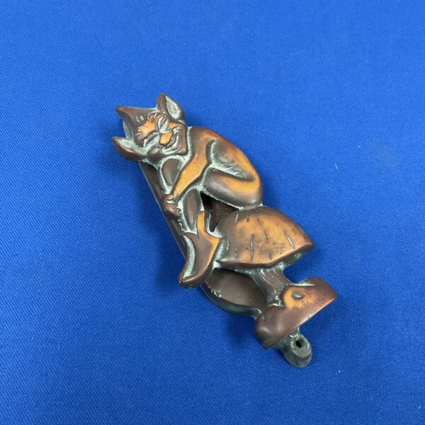 Vintage brass pixie door knocker on a toadstool base.