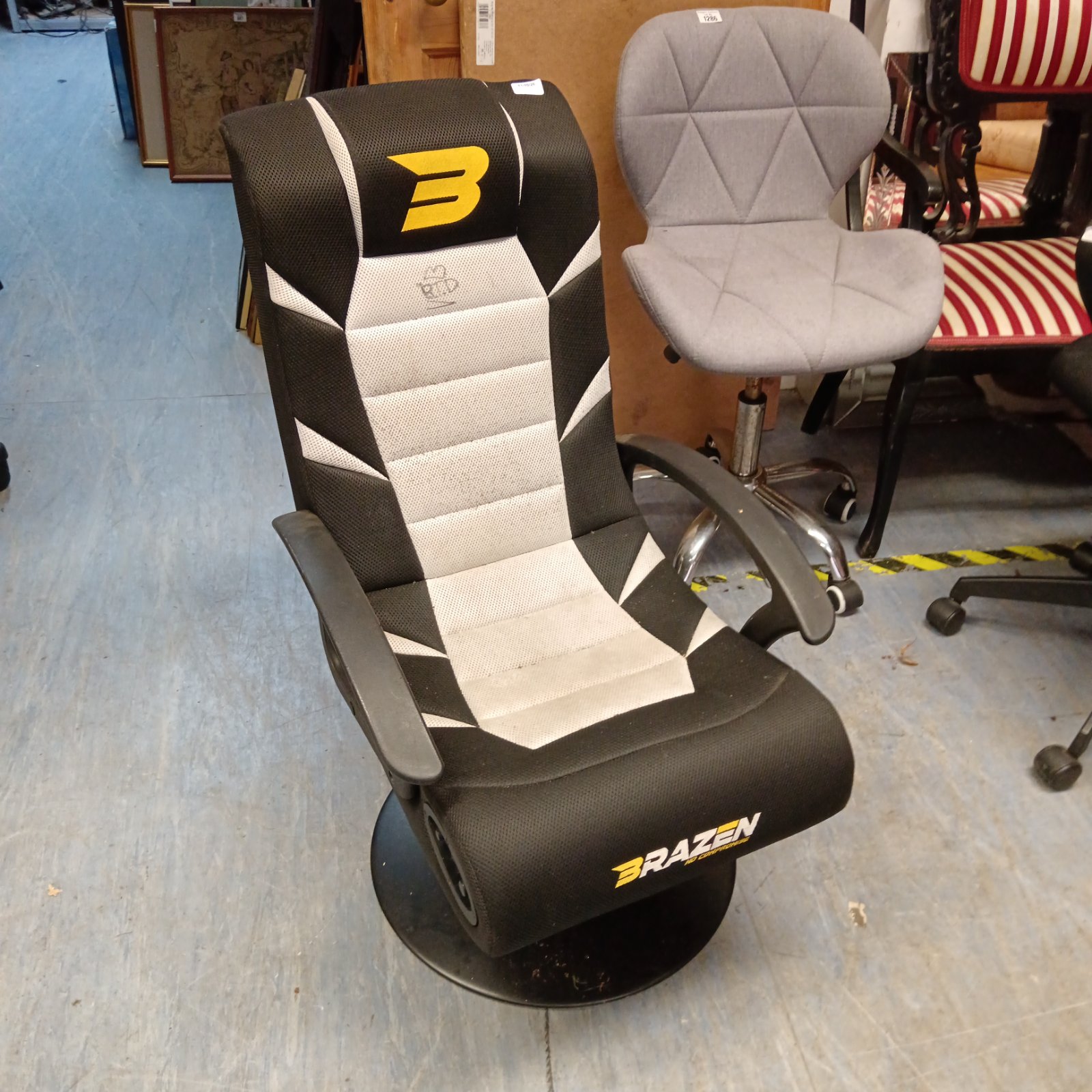 Front view of a black and white Brazen gaming chair.