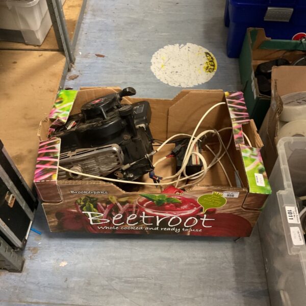 Vintage Briggs & Stratton single cylinder petrol engine with red lever.