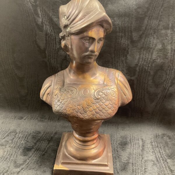 Antique bronze bust of a Greek warrior with detailed helmet.