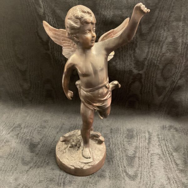 Antique bronze cherub sculpture with wings, detailed patina.