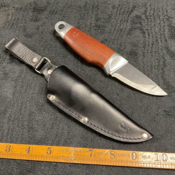 Brusletto sheath knife with leather sheath, angled view.
