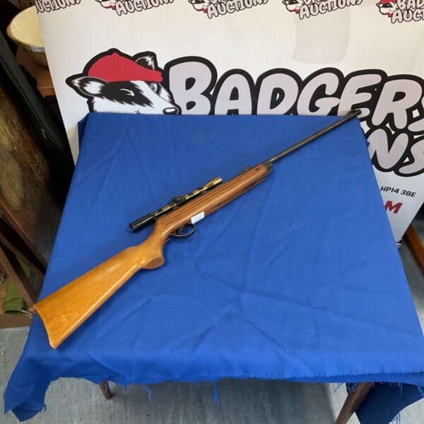 Vintage BSA Meteor air rifle with scope, showing wear and patina.