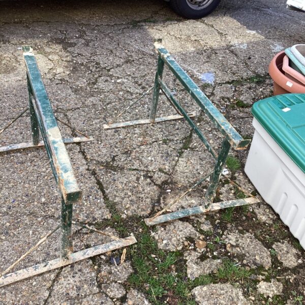 Set of rusty metal builders trestles for workshop use.