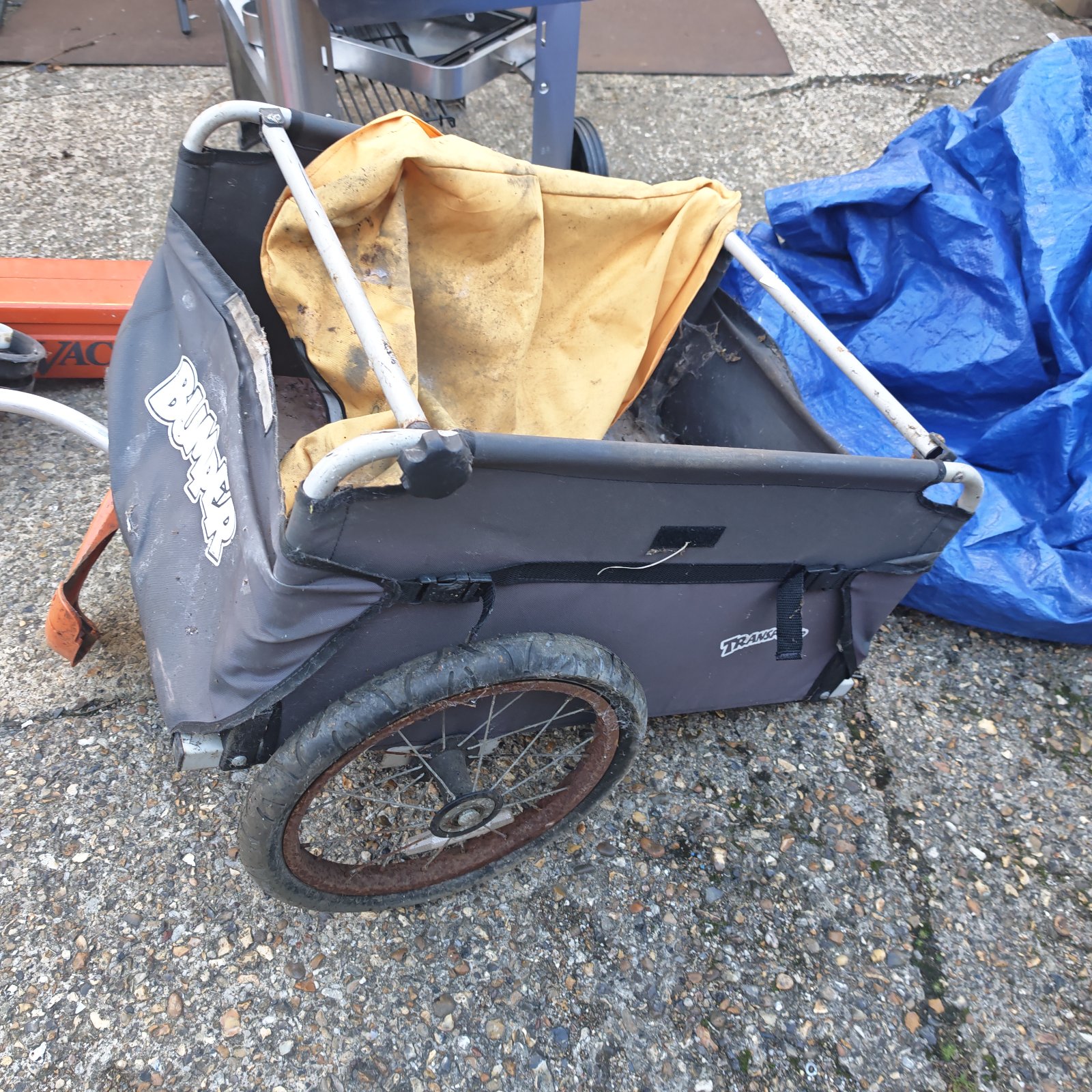 Grey Bumper transporter bicycle trailer with yellow liner and single wheel