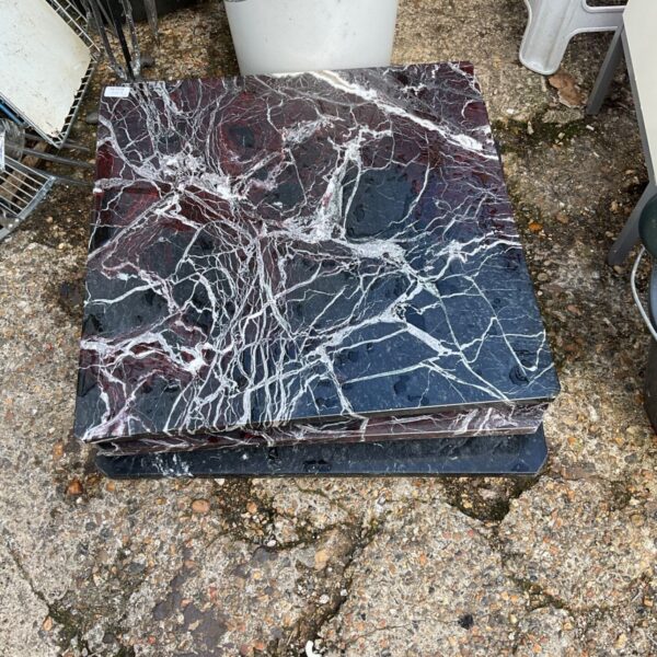 Close-up of burgundy marble effect tiles with white veining.