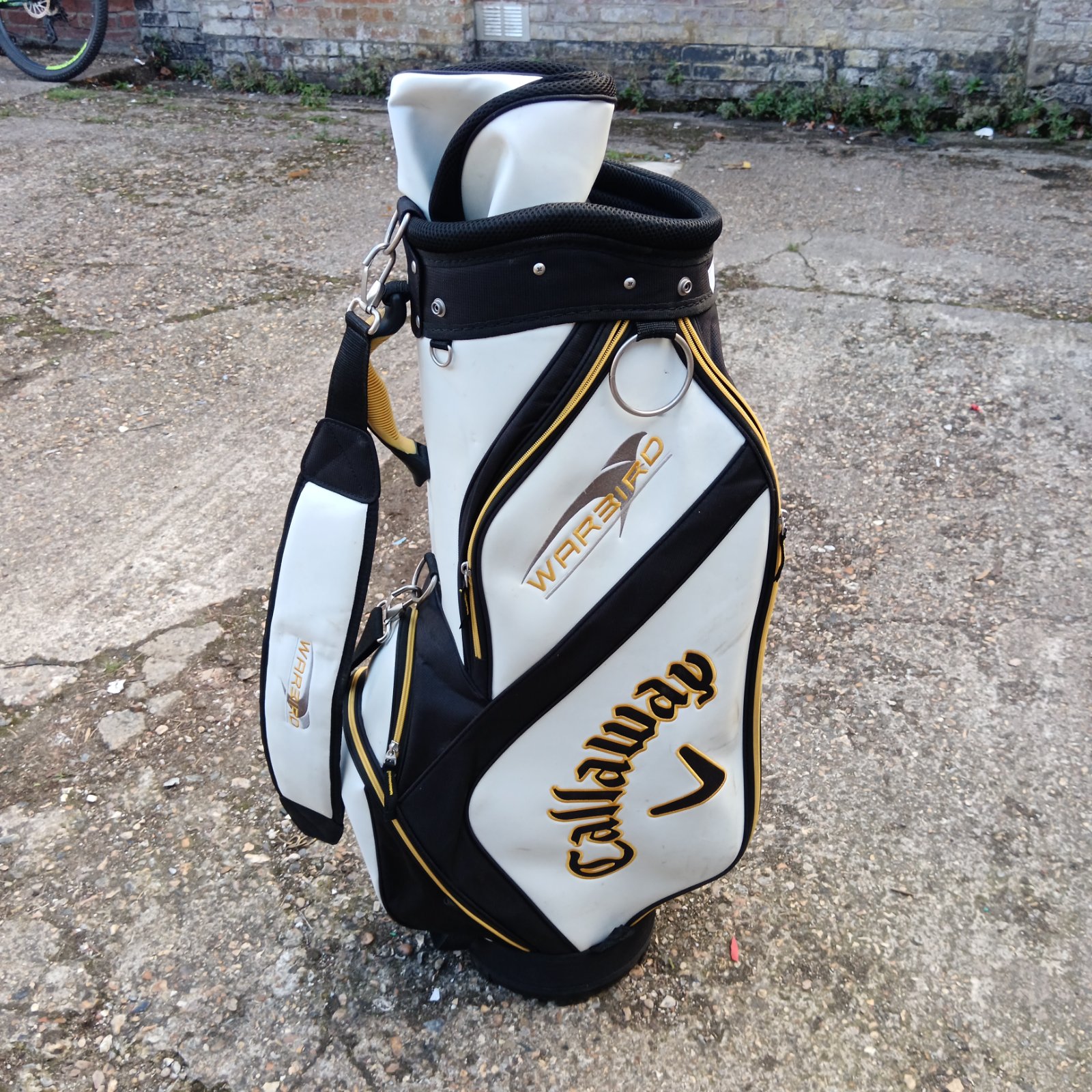 White and black Callaway Warbird Tour golf bag with red accents.