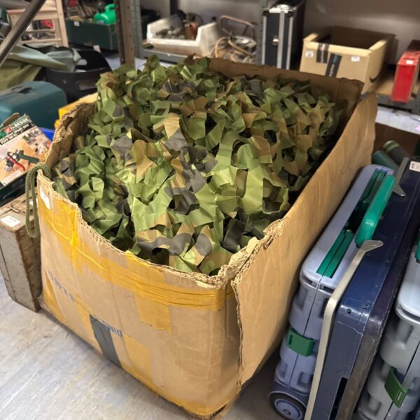Large box filled with green and brown camo netting.