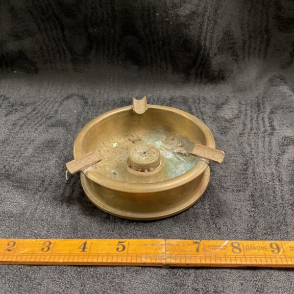 Vintage 1944 cannon shell ashtray with ruler for scale.