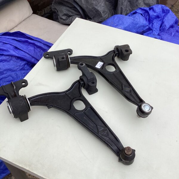 Used car suspension arm with MVT 02/2021 marking for vehicle repair.