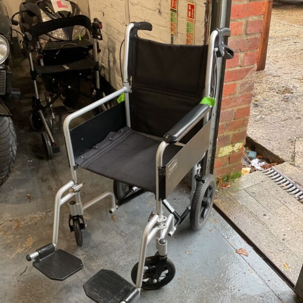 Care Co folding wheelchair with black seat and silver frame